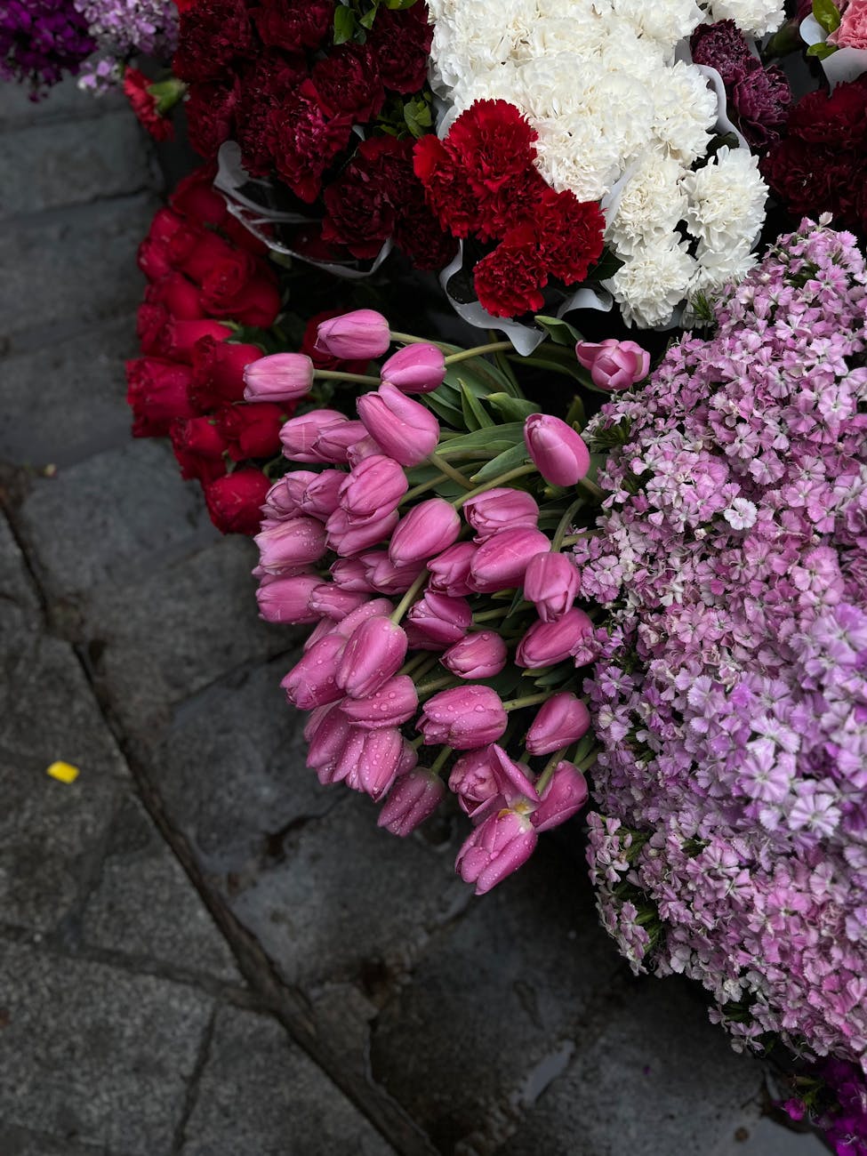 vibrant display of mixed flowers on cobblestone